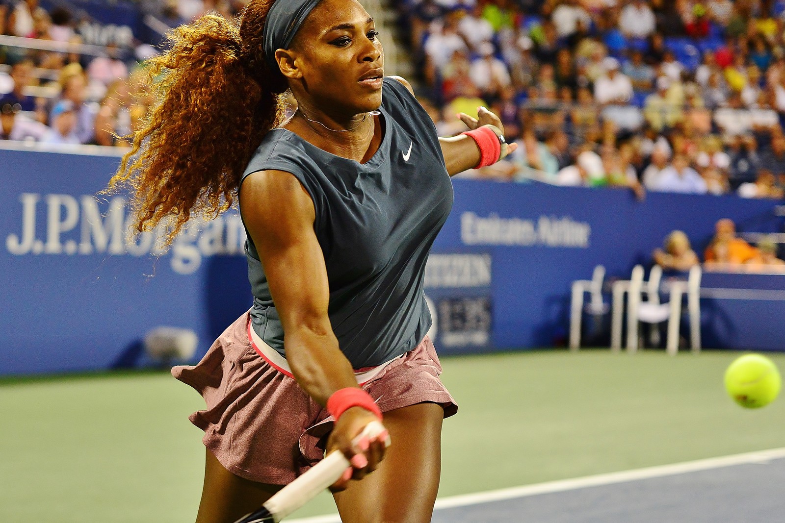 Serena Williams follows through on a forehand in a Nike kit during a match at the 2013 US Open