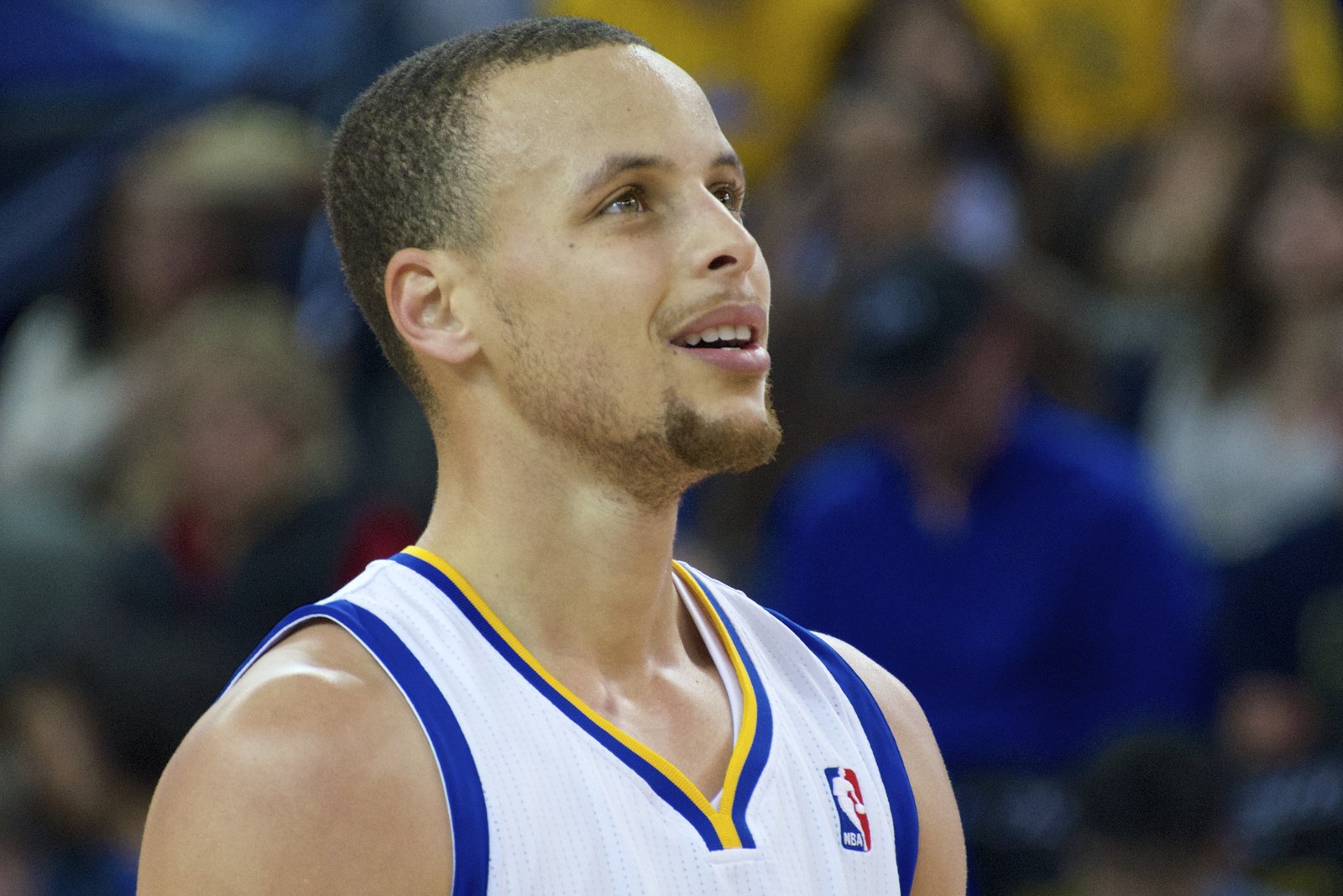 Stephen Curry looks upward mid-game in a white Golden State Warriors jersey